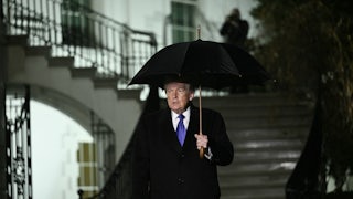 Donald Trump walks to speak to reporters as he departs from the South Lawn of the White House.