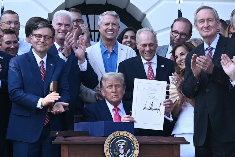 Donald Trump shows his signature on the “Big Beautiful Bill Act” at the White House in Washington, D.C.