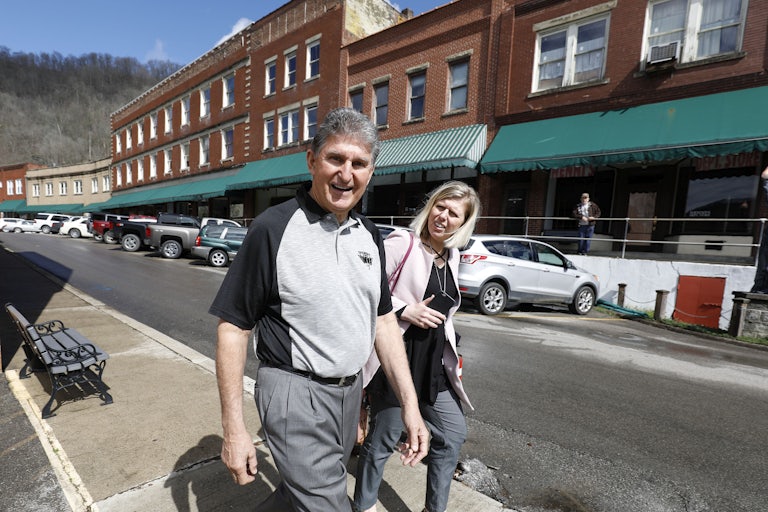 Manchin walks to a meeting with coal miners