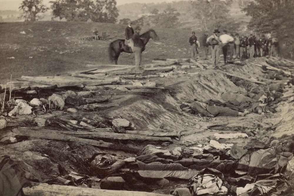 Bodies of dead confederate soldiers awaiting burial lay in a ditch called “Bloody Lane” during the Battle of Antietam.
