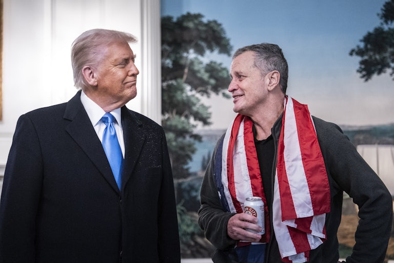 Donald Trump smiles at Mark Fogel during a press conference in the White House