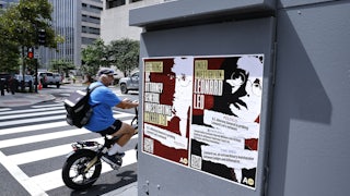 Two posters read "Breaking: D.C. attorney general investigating Leonard Leo" and "Under investigation: Leonard Leo."