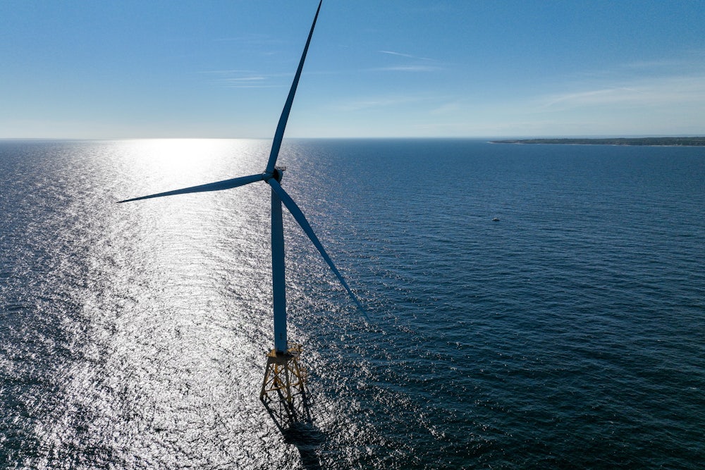 A wind turbine rises up out of the Atlantic Ocean.
