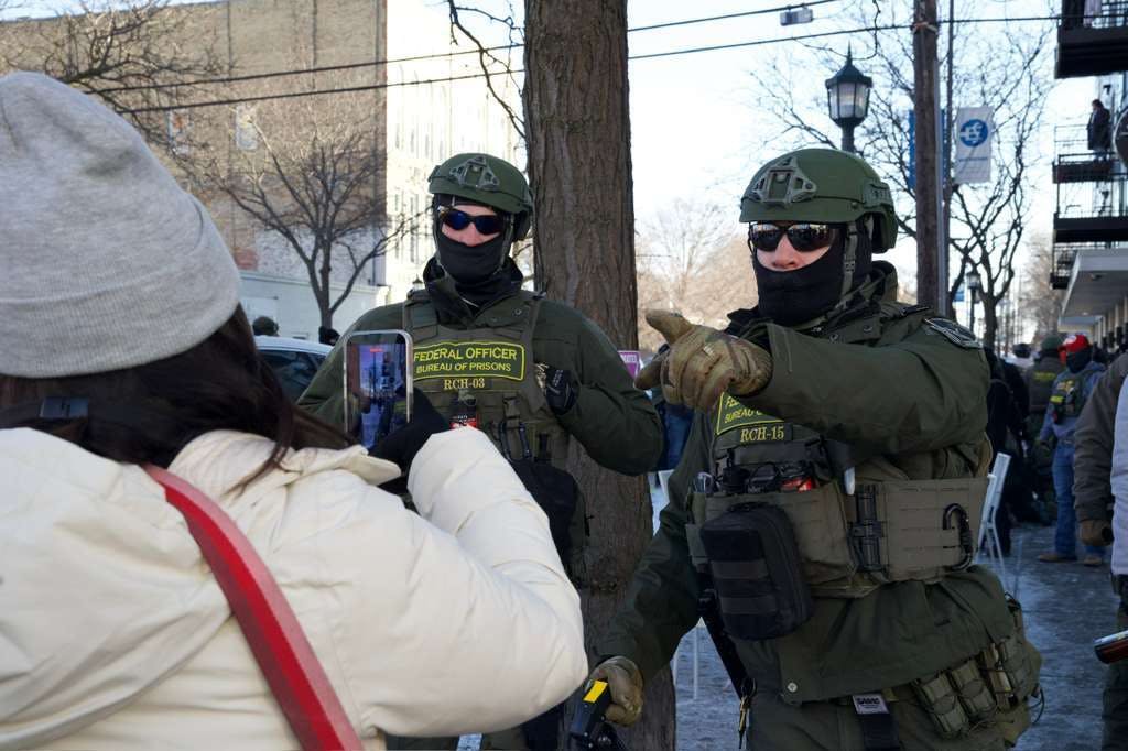 Bureau of Prisons officers near the scene in Minneapolis where a man was shot dead by federal agents
