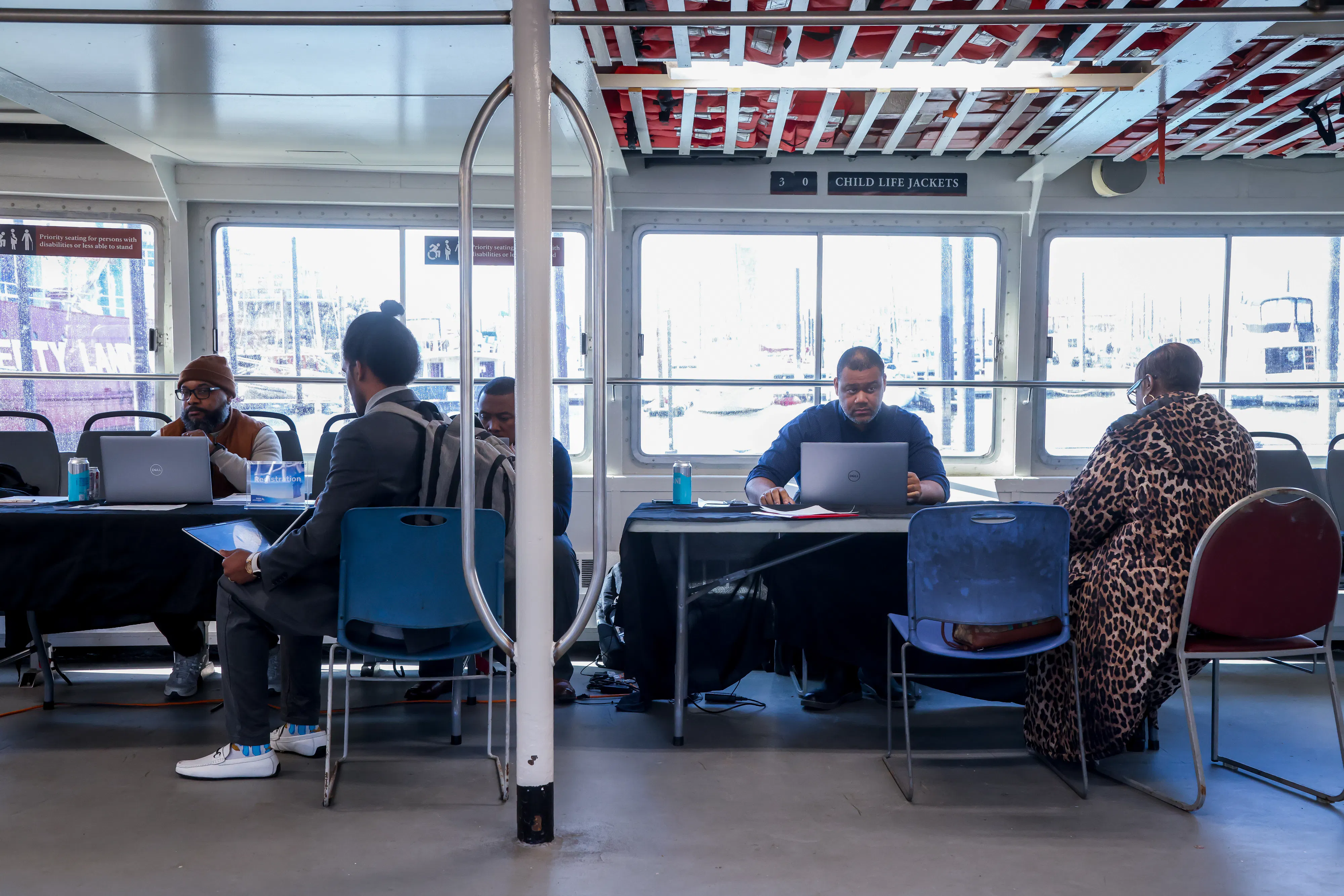 Recruiters speak to jobseekers during a job fair