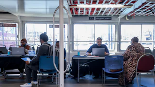 Recruiters speak to jobseekers during a job fair