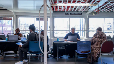 Recruiters speak to jobseekers during a job fair
