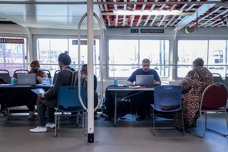 Recruiters speak to jobseekers during a job fair