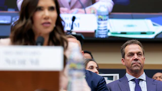 Bryon Noem looks on as Kristi Noem testifies in Congress.