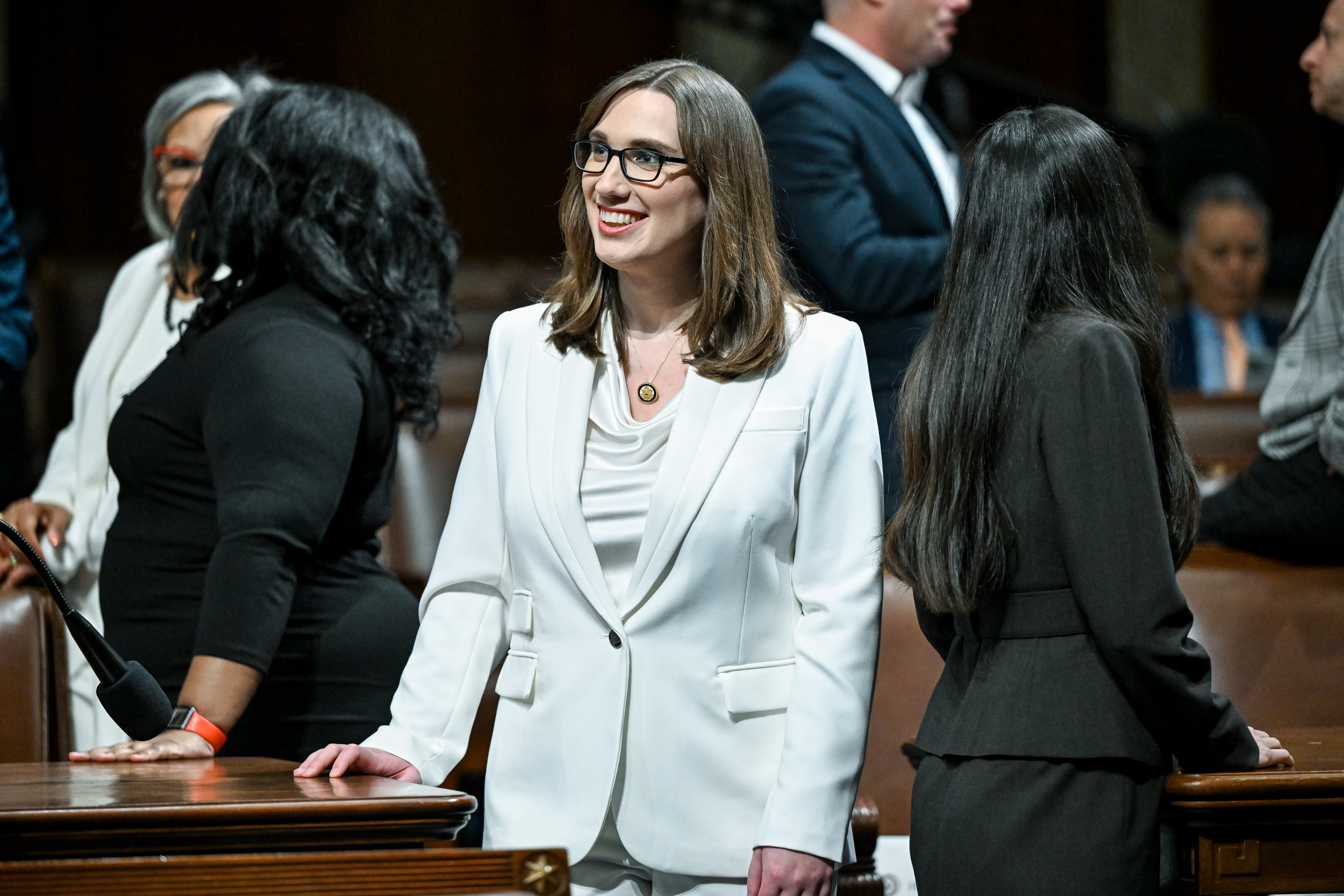 Representative Sarah McBride smiles while standing in Congress ahead of Donald Trump's State of the Union