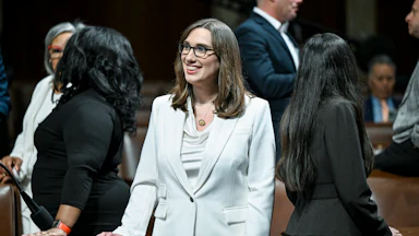 Representative Sarah McBride smiles while standing in Congress ahead of Donald Trump's State of the Union
