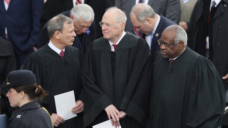 Justice Anthony Kennedy stands between Chief Justice John Roberts and Justice Clarence Thomas at President Donald Trump's inauguration.