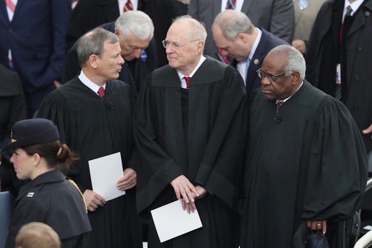 Justice Anthony Kennedy stands between Chief Justice John Roberts and Justice Clarence Thomas at President Donald Trump's inauguration.