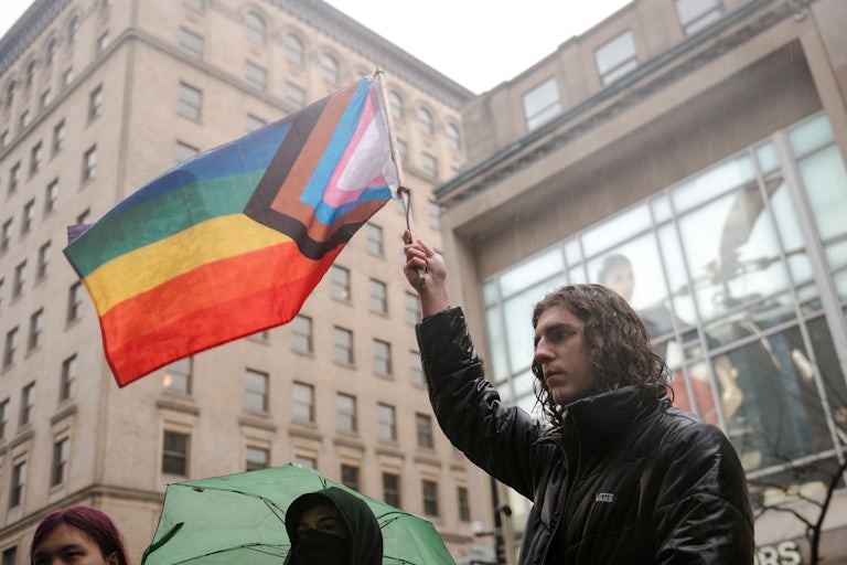 Someone waves a Pride flag
