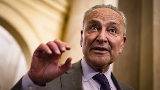 Senator Chuck Schumer gesticulates while talking.