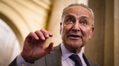 Senator Chuck Schumer gesticulates while talking.