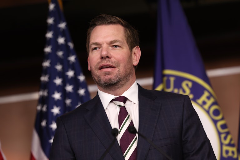 Eric Swalwell speaks into microphones