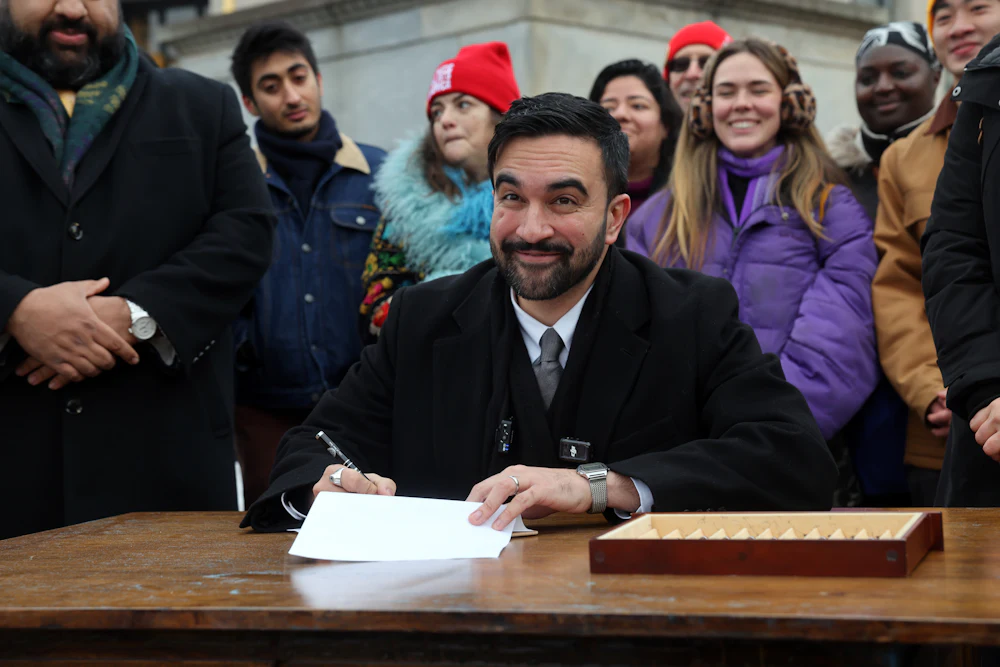 New York Mayor Zohran Mamdani, who has proposed raising the city’s minimum wage to $30 by 2030, signs executive orders in Brooklyn
