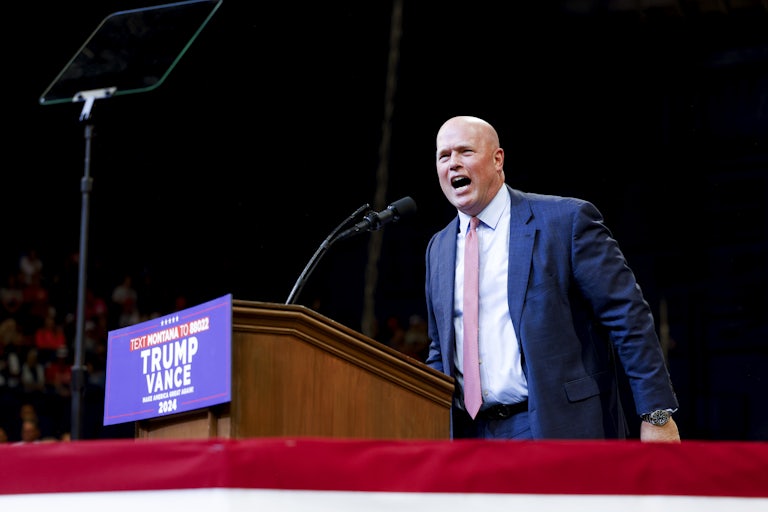 Matt Whitaker shouts at a podium during a Donald Trump rally