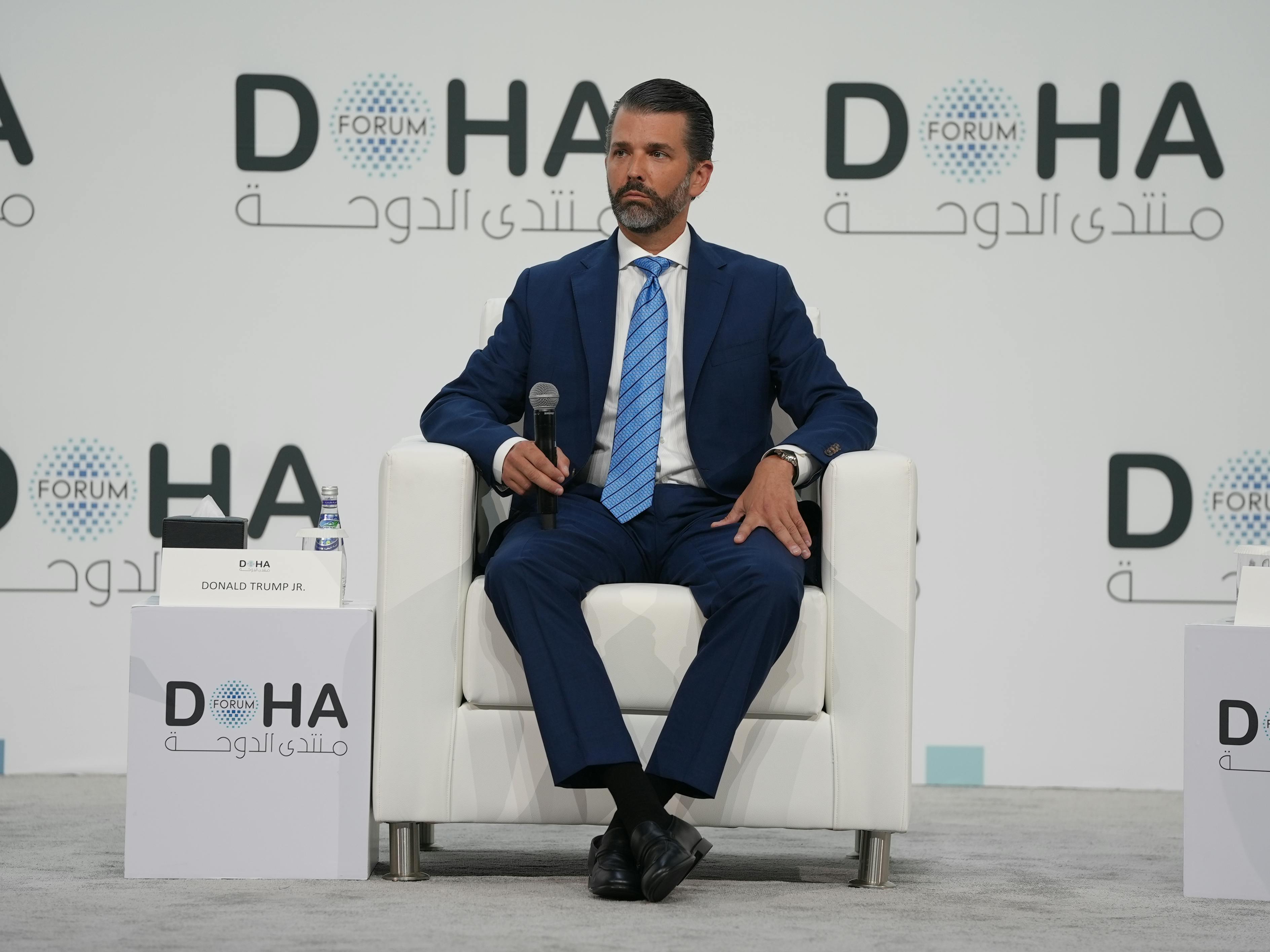 Donald Trump Jr. sits in a chair at the Doha Forum on December 7, 2025.