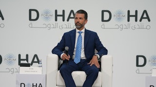 Donald Trump Jr. sits in a chair at the Doha Forum on December 7, 2025.