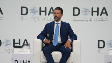 Donald Trump Jr. sits in a chair at the Doha Forum on December 7, 2025.