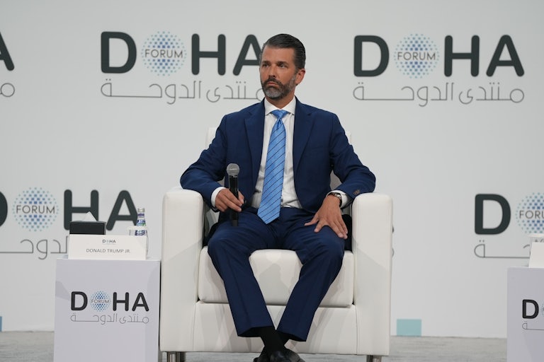 Donald Trump Jr. sits in a chair at the Doha Forum on December 7, 2025.