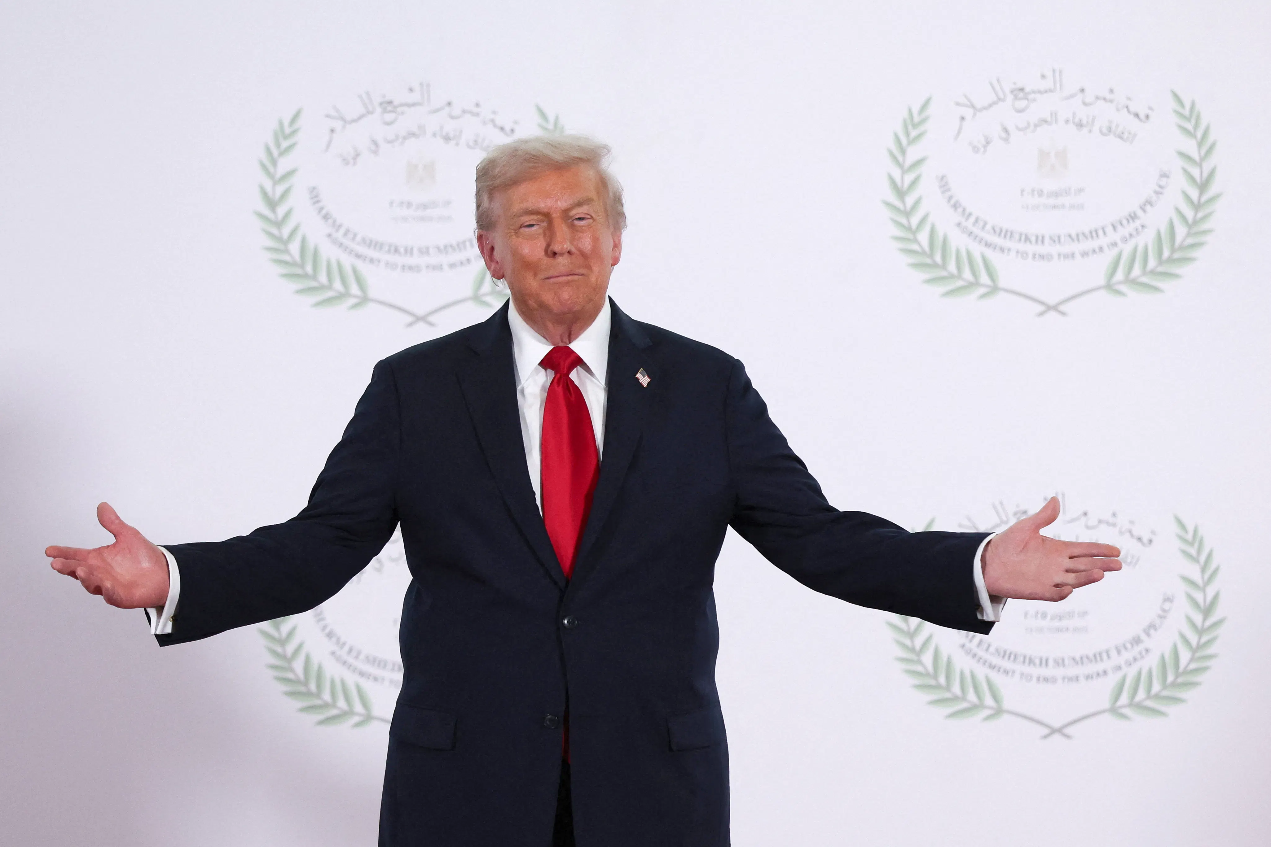 Donald Trump holds out his arms 