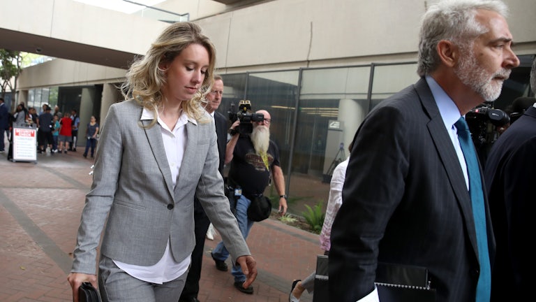 Former Theranos founder Elizabeth Holmes leaves the courthouse where she is standing trial for fraud.