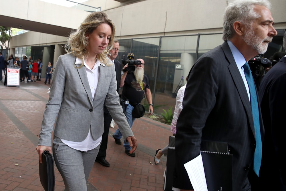 Former Theranos founder Elizabeth Holmes leaves the courthouse where she is standing trial for fraud.