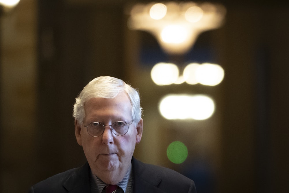A close-up of Senate Minority Leader Mitch McConnell as he walks through the U.S. Capitol.