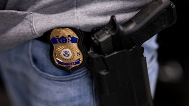 An ICE agent's badge and gun