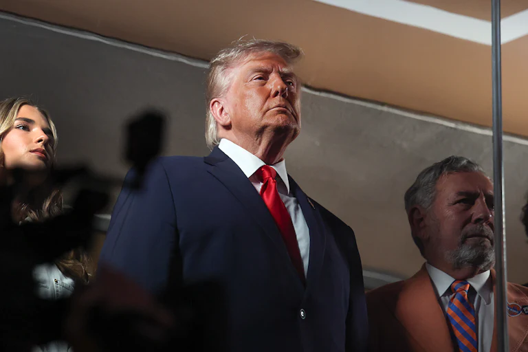 Donald Trump stands in Madison Square Garden during the Knicks game