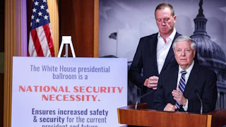 Senator Lindsey Graham speaks at a podium next to a sign describing why Donald Trump's ballroom is needed for national security