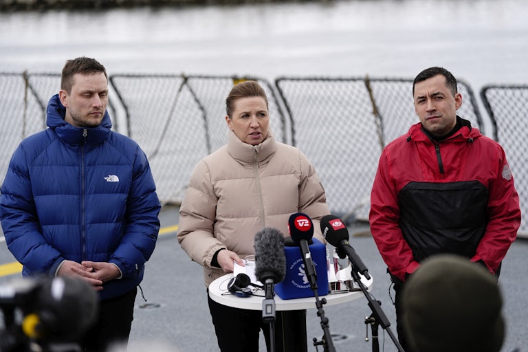Greenland Prime Minister Jens-Frederik Nielsen, Danish Prime Minister Mette Frederiksen, and Greenland's acting head of government Múte Bourup Egede stand in front of reporters at a press conference
