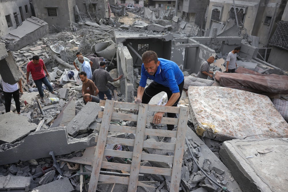 Palestinians search for survivors and casualties in the rubble after an Israeli strike in the northern Gaza Strip