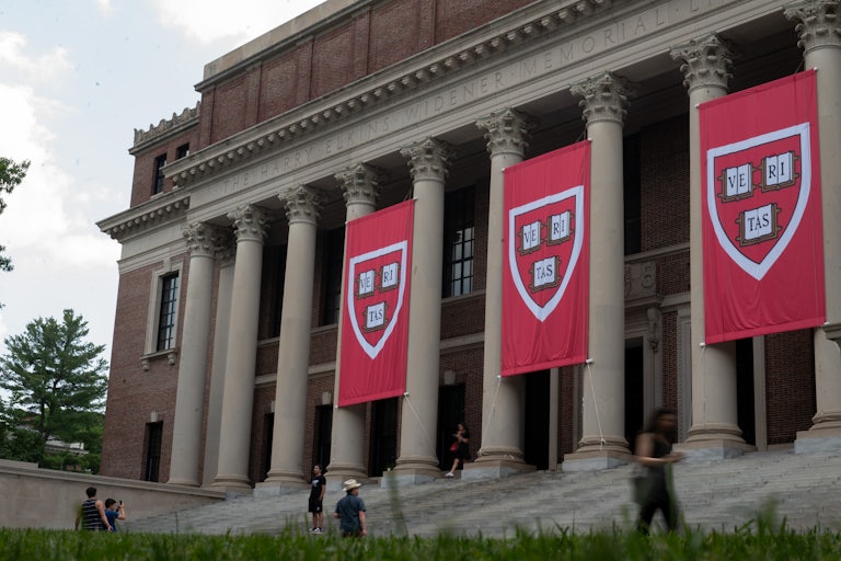People walk outside the Harvard University library