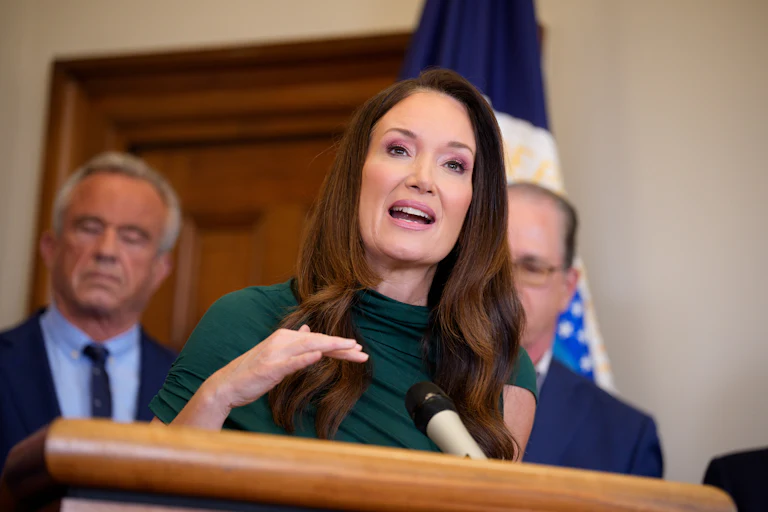 U.S. Agriculture Secretary Brooke Rollins speaks at podium with RFK Jr. behind her