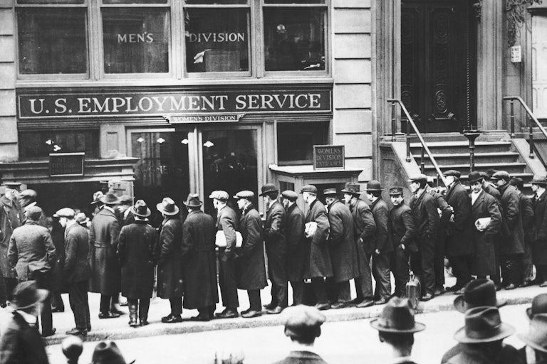 Men are waiting in line, in front of the Office of the U. S. employment Bureau in New York City. 