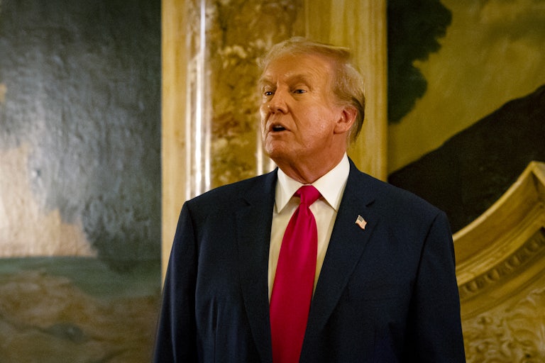 Donald Trump tilts his head back slightly and speaks with his mouth wide open