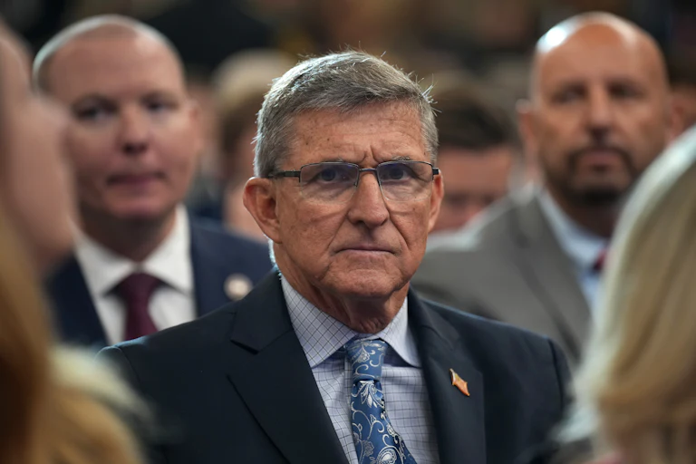 Former national security advisor Michael Flynn sits in an audience.