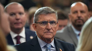 Former national security advisor Michael Flynn sits in an audience.