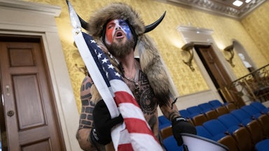 Jacob Chansley, the self-described "QAnon Shaman," shouts while standing in the U.S. Capitol during the January 6 riot