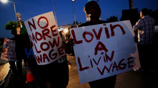 Fast-food workers and supporters organized by the Service Employees International Union protest outside of a Burger King in Los Angeles, California