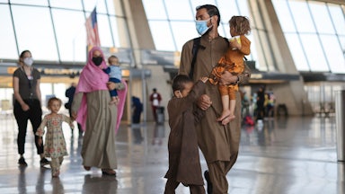 Refugees arrive at Dulles International Airport after being evacuated from Kabul following the Taliban takeover of Afghanistan. 