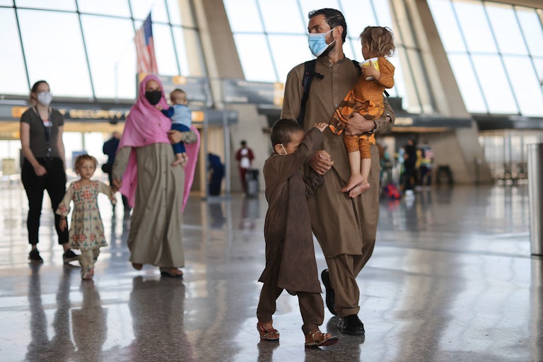Refugees arrive at Dulles International Airport after being evacuated from Kabul following the Taliban takeover of Afghanistan. 