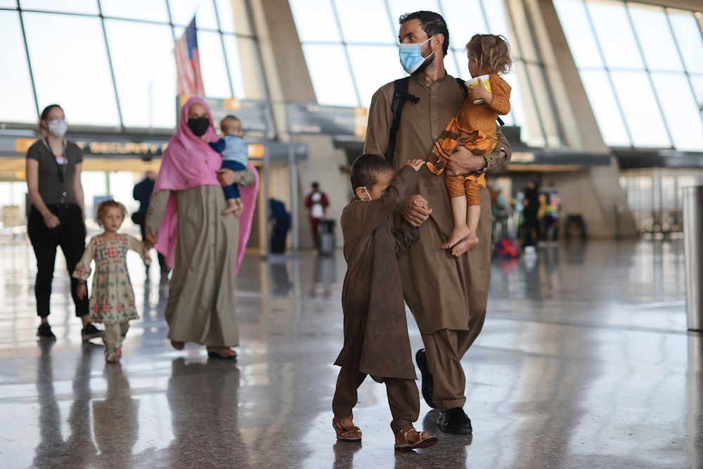 Refugees arrive at Dulles International Airport after being evacuated from Kabul following the Taliban takeover of Afghanistan.