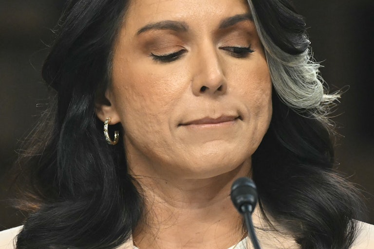 Tulsi Gabbard bites her lip while testifying before the Senate Intelligence Committee