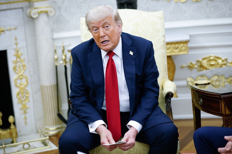 Donald Trump sits in the White House