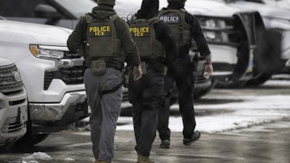 Federal immigration agents walk in a parking lot in Minneapolis, Minnesota